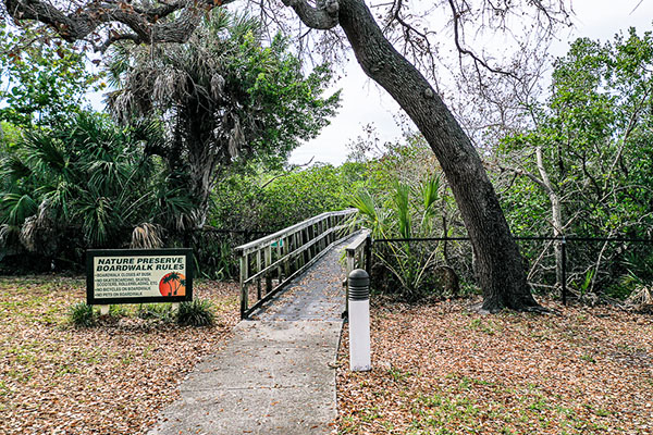 Nature preserve boardwalk rules sign as you enter.