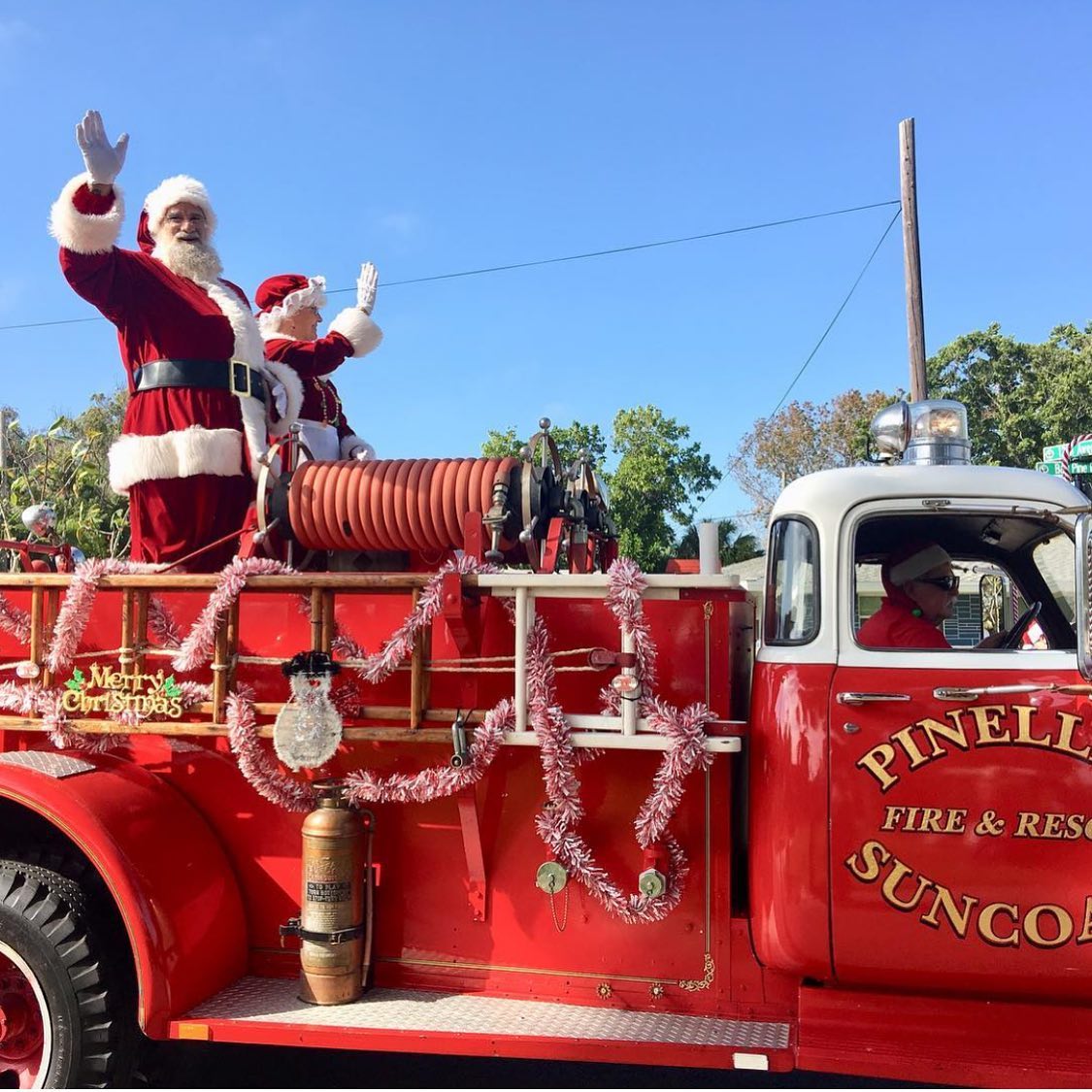 Santa and his wife ride on Pinelle Fire and rescue truck in a Christmas parade