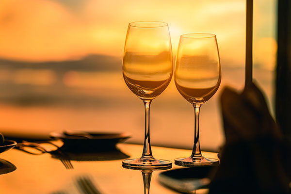 empty wineglasses at sunset